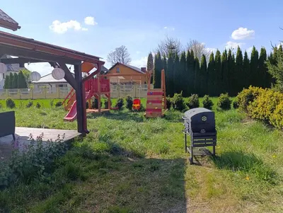 a backyard with a grill and a playground at Bukszpanowa Alejka domek całoroczny, okolica Ojcowski Park Narodowy in Milonki