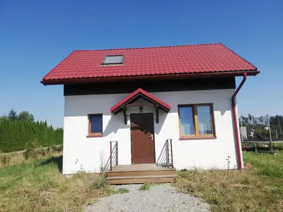 a small white house with a red roof at Bukszpanowa Alejka domek całoroczny, okolica Ojcowski Park Narodowy in Milonki