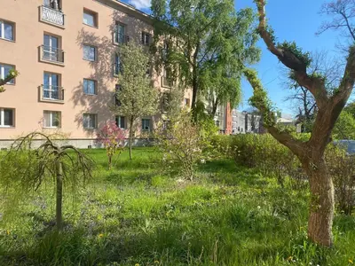 a garden in front of an apartment building at Krakow Center - Chill Spot by the River in Kraków