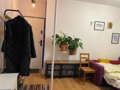 a bedroom with a mirror and a bed and a chair at Krakow Center - Chill Spot by the River in Kraków