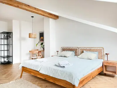 a bedroom with a large bed with white walls at Premium Jacuzzi with Air conditioning, Main Square Cracow in Kraków