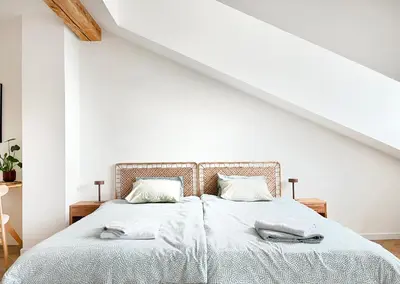 a white bedroom with a bed with two pillows at Premium Jacuzzi with Air conditioning, Main Square Cracow in Kraków
