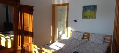 a bedroom with a bed and a mirror in a room at Nowy Dwór w Goszycach in Goszyce