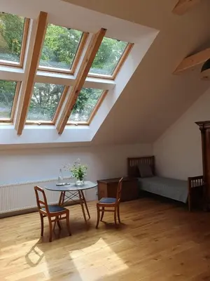 a room with a table and chairs and windows at Nowy Dwór w Goszycach in Goszyce