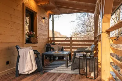 a porch of a cabin with a table and chairs at Solankowe Zacisze Żmiąca in Żmiąca