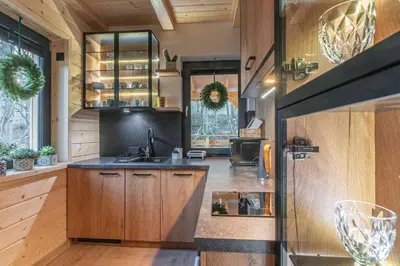 a kitchen with wooden cabinets and a counter top at Solankowe Zacisze Żmiąca in Żmiąca