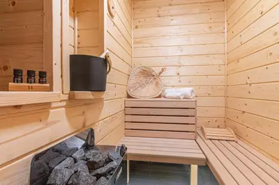 a sauna with a bench in a wooden cabin at Solankowe Zacisze Żmiąca in Żmiąca
