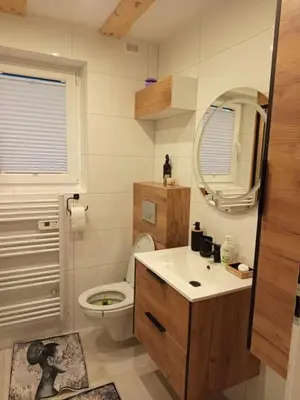 a bathroom with a toilet and a sink and a mirror at Domek pod lasem in Toporzysko