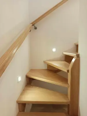 a staircase with wooden steps in a room at Domek pod lasem in Toporzysko