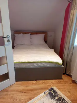 a small bedroom with a bed in a room at Domek pod lasem in Toporzysko