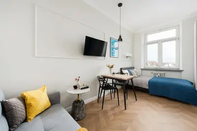 a living room with a bed and a table at Silver Suite Old Town Apartament in Kraków