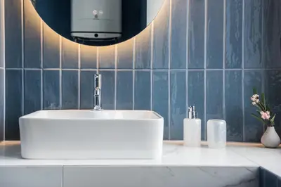 a bathroom with a white sink and a mirror at Silver Suite Old Town Apartament in Kraków