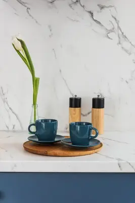 two coffee cups and a vase on a table at Azure Haven Old Town Apartament in Kraków