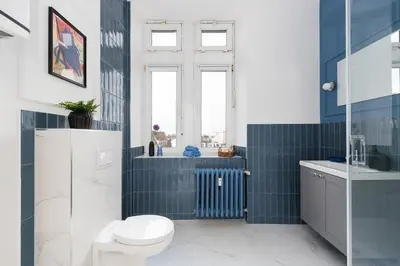 a bathroom with a toilet and a sink at Azure Haven Old Town Apartament in Kraków