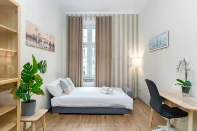 a hotel room with a bed and a desk at Starowiślna 38 Charming Apartment by BookingHost in Kraków