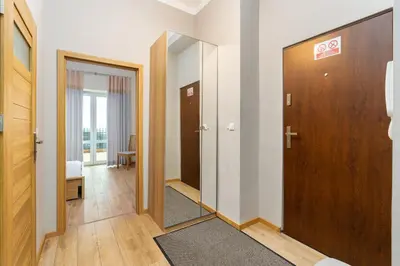 a hallway with two doors and a mirror at Starowiślna 38 Charming Apartment by BookingHost in Kraków