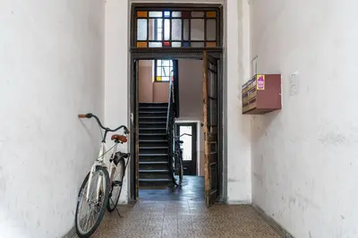 a bike parked in a hallway with a stairway at Starowiślna 38 Charming Apartment by BookingHost in Kraków