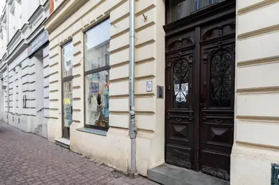 a building with a black door on a street at Starowiślna 38 Charming Apartment by BookingHost in Kraków