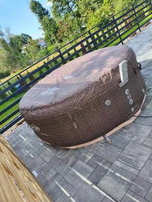 a suitcase sitting on the ground next to a fence at Willa Sielski Zakątek in Raba Wyżna