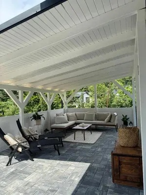 a white pergola with couches and tables on a patio at Willa Sielski Zakątek in Raba Wyżna