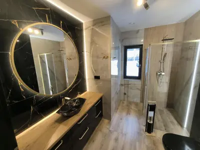 a bathroom with a large mirror and a shower at Willa Sielski Zakątek in Raba Wyżna