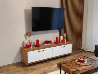 a living room with a tv on the wall at Willa Sielski Zakątek in Raba Wyżna