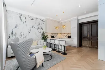 a living room with a couch and a kitchen at Heritage Apartments in Kraków