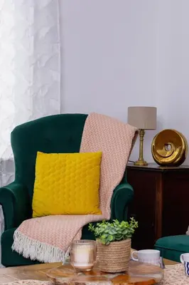 a green chair with a yellow pillow on a table at Słoneczny Apartament 2 Sypialnie, Biurko & Klimatyzacja by Rent like home in Kraków