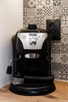 a black and white coffee maker sitting on a table at Apartment Cracow Wawrzyńca by Noclegi Renters in Kraków