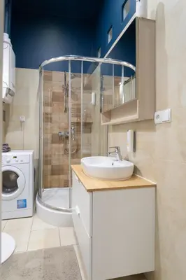 a bathroom with a shower and a sink and a toilet at Apartamenty Łazarza 17 in Kraków