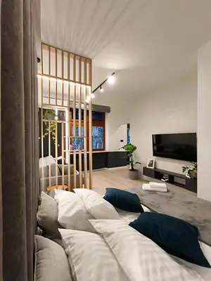 a living room with a couch and a television at Apartamenty Łazarza 17 in Kraków