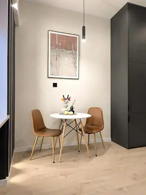 a dining room with a table and two chairs at Apartamenty Łazarza 17 in Kraków