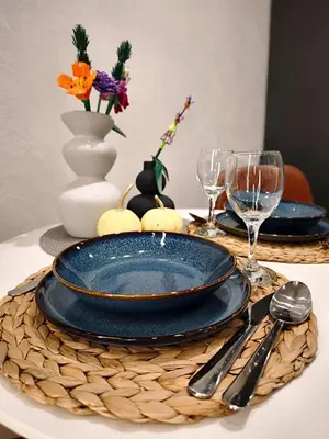 a table with plates and glasses on a table at Apartamenty Łazarza 17 in Kraków