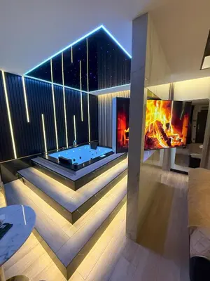 a house with a hot tub and a fireplace at Wiślane Tarasy 2 VIP Apartamenty JACUZZI in Kraków