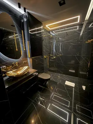 a black bathroom with a toilet and a sink at Wiślane Tarasy 2 VIP Apartamenty JACUZZI in Kraków