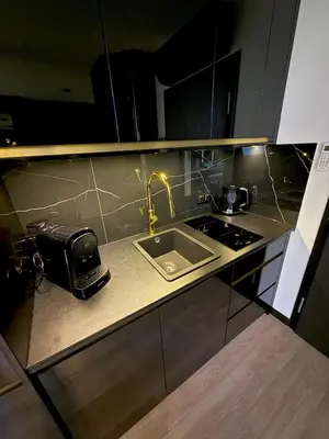 a kitchen counter with a sink and a stove at Wiślane Tarasy 2 VIP Apartamenty JACUZZI in Kraków