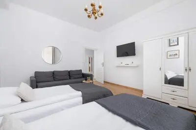 a white room with two beds and a couch at Apartament w Sercu Krakowa z Dwoma Sypialniami by Rent like home in Kraków