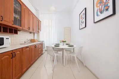 a kitchen with a white table and chairs in it at Apartament w Sercu Krakowa z Dwoma Sypialniami by Rent like home in Kraków