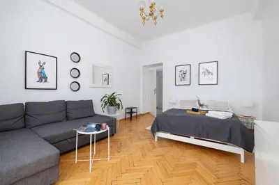 a living room with a couch and a table at Apartament w Sercu Krakowa z Dwoma Sypialniami by Rent like home in Kraków