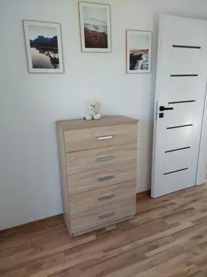 a teddy bear sitting on a dresser in a room at Plutowka in Zawoja