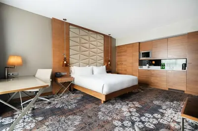 a hotel room with a bed and a desk at DoubleTree by Hilton Krakow Hotel & Convention Center in Kraków