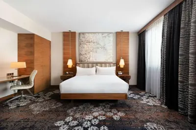 a hotel room with a bed and a desk at DoubleTree by Hilton Krakow Hotel & Convention Center in Kraków