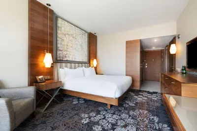 a hotel room with two beds and a television at DoubleTree by Hilton Krakow Hotel & Convention Center in Kraków