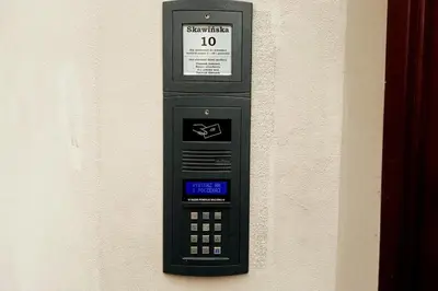 a cell phone is attached to a wall at Skawińska Street Apt in Kraków