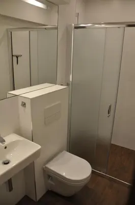 a bathroom with a shower and a toilet and a sink at Willa Relaks in Wieliczka