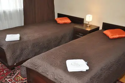 two beds in a hotel room with towels on them at Willa Relaks in Wieliczka