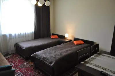 a hotel room with two beds and a window at Willa Relaks in Wieliczka