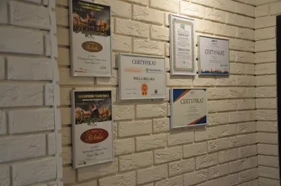 a wall with posters on a brick wall at Willa Relaks in Wieliczka