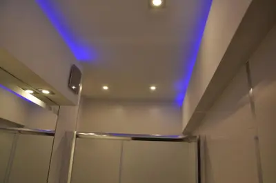 a bathroom with a blue light on the ceiling at Willa Relaks in Wieliczka