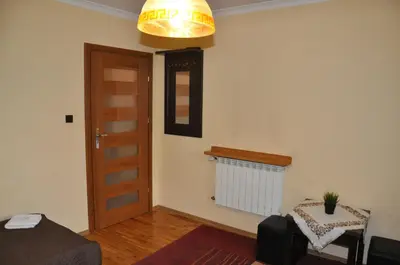 a living room with a door and a lamp at Willa Relaks in Wieliczka